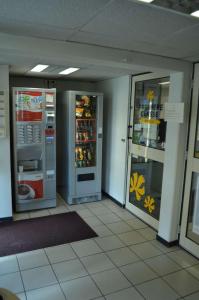 an empty room with two refrigerators in a store at Premiere Classe Chambery in Chambéry