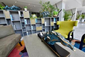 a living room with a couch and a table and chairs at Bram Hotel in Jeddah