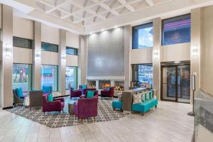 a lobby with chairs and a fireplace in a building at La Quinta by Wyndham Glenwood Springs in Glenwood Springs