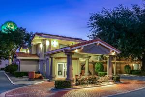 a house with a lit up front yard at La Quinta Inn by Wyndham Dallas Uptown in Dallas