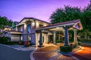 a house with a gazebo in front of it at La Quinta Inn by Wyndham Dallas Uptown in Dallas