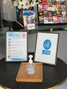 a bottle of water on a table next to a sign at Hotel Phenix in Brussels