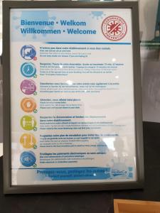 a sign for the wilsen wellatownorenorenorenorenorenoren website at Hotel Phenix in Brussels