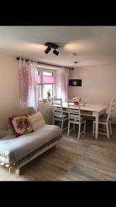 a living room with a bed and a table and chairs at Apart am Inn in Pfunds