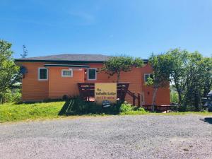 a house with a sign in front of it at Valhalla near L'Anse aux Meadows in L'Anse aux Meadows
