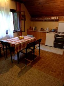 a kitchen with a table and chairs in a room at Apartment Sijakovic in Mokra Gora
