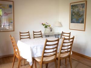 a dining room with a white table and chairs at Haus Waterblick in Waabs