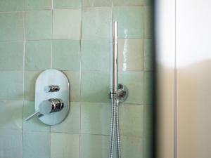 a shower with a glass door and a shower head at Haus Waterblick in Waabs