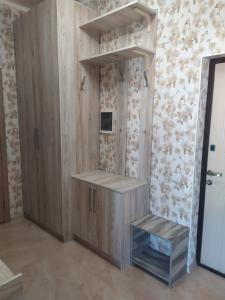 Zimmer mit einem Holzschrank und einem TV an der Wand in der Unterkunft Квартира у моря - apartment by the sea - Odessa in Odessa