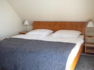 a bedroom with a large bed with two pillows at Haus Waterblick in Waabs