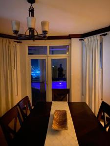 a dining room with a table and a window at Villa Xona in Castries