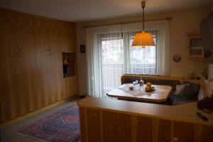 a living room with a table and a couch at Apartment Grüner Baum Alpendorf in Sankt Johann im Pongau