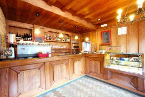a bar in a restaurant with wooden walls and ceilings at Rifugio Palafavera in Val di Zoldo
