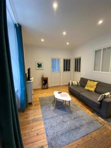 a living room with a couch and a table at La Mettrie in Saint Malo