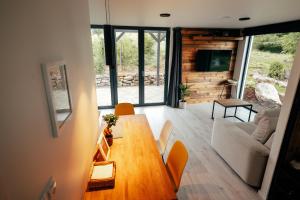 a living room with a wooden table and a couch at Magic Places 57-340 in Duszniki Zdrój