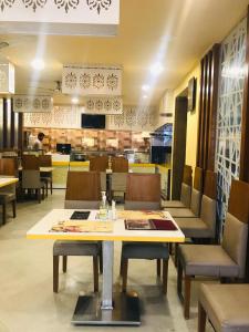 a dining room with a table and chairs in a restaurant at Empark in Bengaluru