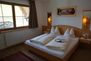 a bedroom with a bed with two pillows on it at Haus Dorfblick in Gerlos