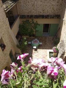 a view of a patio with flowers and a table at Le Térébinthe B&B in Lauris
