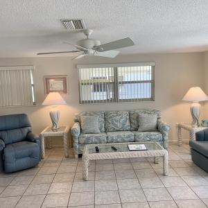 a living room with a couch and a table at Island House Beach Resort 23 in Point O'Rocks