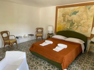 a bedroom with a bed and a painting on the wall at Charming Villa in Capri