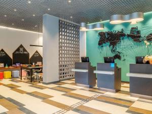 a lobby with a map of the world on the wall at ibis Styles SP Centro in Sao Paulo