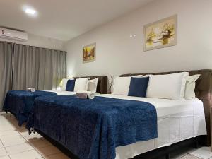 B & A Suites Inn Hotel - Quarto Luxo Safira客房内的一张或多张床位