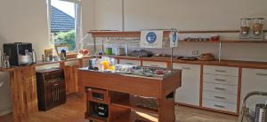 a large kitchen with a counter in the middle at Akzent Hotel Alte Direktionsvilla Kupfermühle in Flensburg