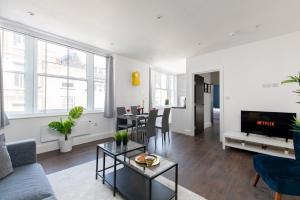 a living room with a couch and a table at homely - Central London Liverpool Street Apartments in London