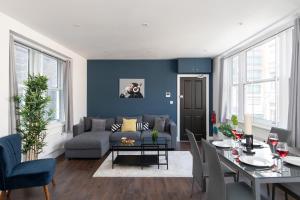 a living room with a couch and a table at homely - Central London Liverpool Street Apartments in London