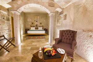 A bed or beds in a room at Imperial Cave Suites & Spa