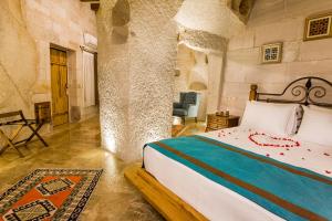 A bed or beds in a room at Imperial Cave Suites & Spa
