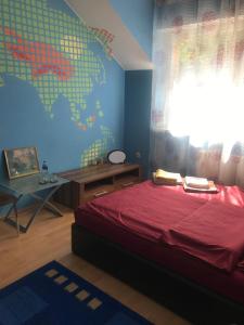 a bedroom with a bed and a map of the world at DOM OTWARTY DLA GOŚCI in Gdynia