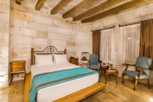 A bed or beds in a room at Imperial Cave Suites & Spa