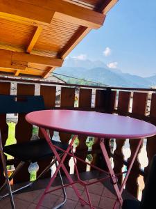 a purple table and chairs on a balcony at Appartamento Primiero San Martino di Castrozza in Fiera di Primiero