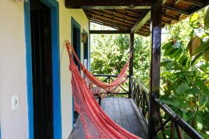 a hammock on the porch of a house at Pousada Bemvirá in Arraial d'Ajuda