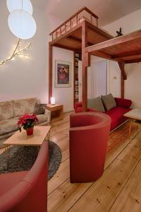 a living room with a red couch and a living room with a couch at Ruhige Ferienwohnung in Kreuzberg in Berlin