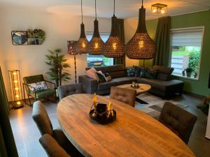 uma sala de estar com uma mesa de madeira e um sofá em Mariposa em Otterlo