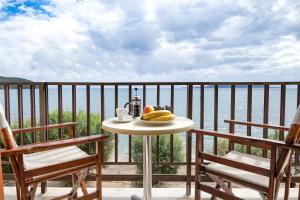 a table with a plate of fruit on a balcony at Hotel Korakakis Beach in Finikounta