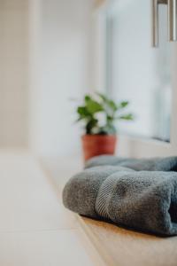 a row of towels sitting on a floor at Stadt Land Fluss Boutique Aparthotel by Zollhaus in Forchheim
