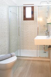 a bathroom with a shower and a toilet and a sink at Apartments Korakakis Beach in Finikounta
