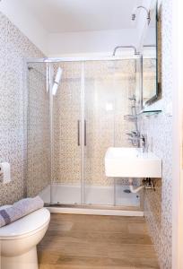 a bathroom with a shower and a toilet and a sink at Apartments Korakakis Beach in Finikounta