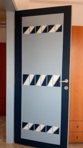 a white door with black and white panels at House Anna Houhlia in Vourvourou