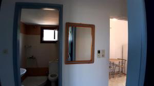 a bathroom with a mirror and a toilet at House Anna Houhlia in Vourvourou