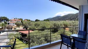 a balcony with a view of the mountains at House Anna Houhlia in Vourvourou