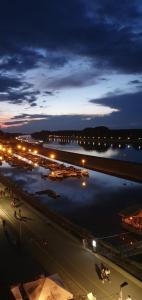 a view of a harbor at night with boats in the water at Studio apartman Ana in Osijek