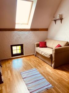 a living room with a couch and a window at Dom w Kratę - koło Karpacza in Łomnica