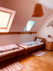 a bedroom with two beds in a attic at Dom w Kratę - koło Karpacza in Łomnica