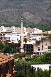 a group of buildings with a smoke stack in a city at Apartamento Sambala in Ontinyent