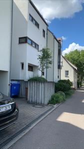 a car parked in front of a white building at City Home 1 in Metzingen