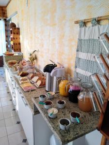 a kitchen with a counter with food on it at Pousada Pica Pau in Urubici